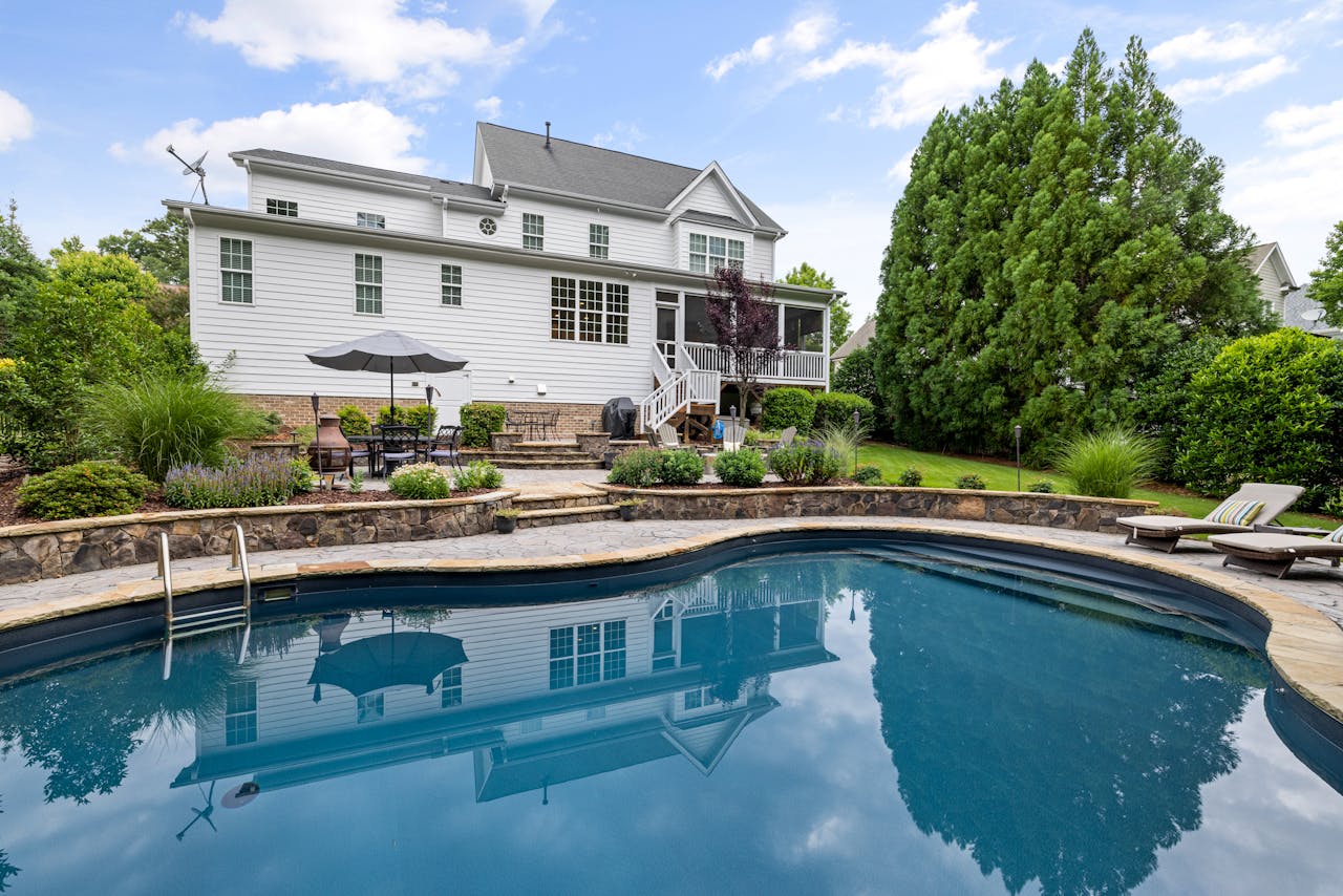 A beautiful suburban house with a pool and landscaped garden in a tranquil neighborhood.